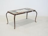 a small table with a tile top on a white floor