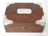 a small wooden box that has a plaque on it