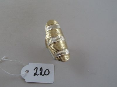 a gold ring on a string with a price tag on it