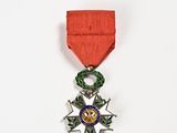 an image of a medal with a red ribbon and a star on it