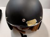 a helmet on a table next to a remote control