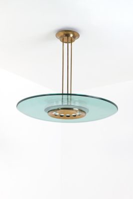 a close up of a light fixture with a circular glass light fixture