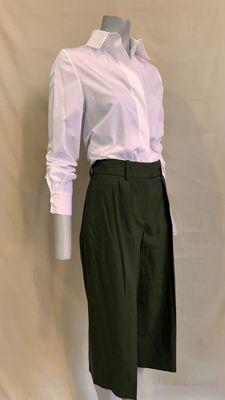 a mannequin wearing a white shirt and black skirt