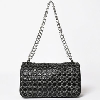 a close up of a black purse on a white background