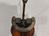 an old brass sundial on a white surface