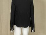 the back of a mannequin wearing a black jacket and white pants