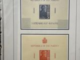 three different stamps are displayed in a white frame on a table