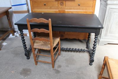 une table, deux chaises et une commode dans une pièce