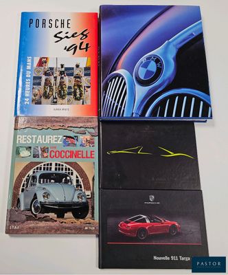 three books on a white table with a red car and a blue car