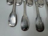 six spoons that are sitting next to each other on a table
