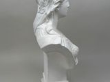white marble bust of a woman with a hat on her head