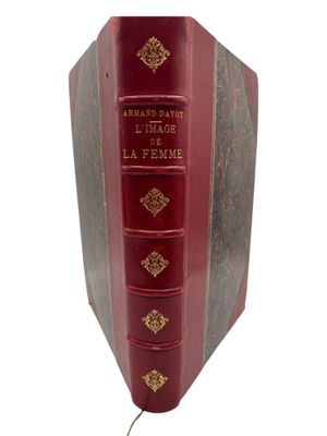 an old red book with gold trimmings on the cover