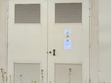 a white building with two doors and a sign on it