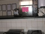 a microwave and a toaster sitting on a counter in a kitchen