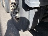 a close up of a truck tire on the road