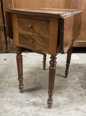 a small wooden table with a drawer on top of it