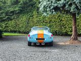 a small blue car that is parked in a parking lot