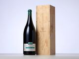 a bottle of wine sitting next to a wooden box