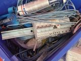 a blue container filled with electronic equipment on a table