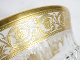 a close up of a glass bowl with gold decoration on it