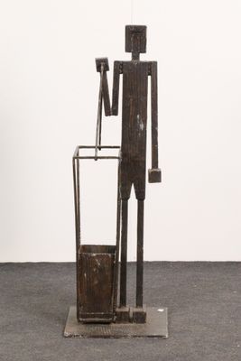 sculpture of a man standing next to a trash can and a trash can