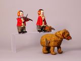 two figurines of clowns and a dog on a table