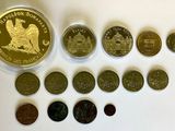 several different coins are arranged in a row on a white surface