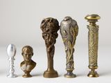 several different types of vases and statues on a white surface