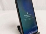 an iphone with a lock on the screen is sitting on a table