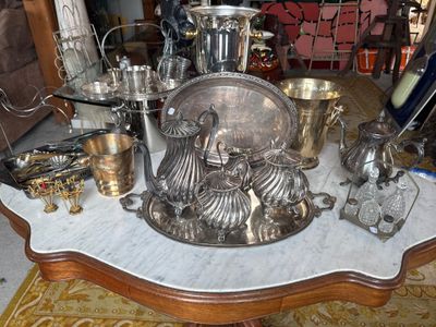 a table that has a lot of silver items on it