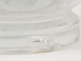 a clear glass bowl with a lid on a white surface