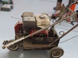 a small lawn mower that is sitting on the floor