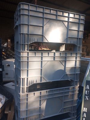 a large stack of crates in a warehouse filled with boxes