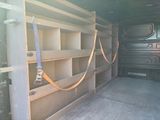 shelves in the back of a truck with a seat belt attached to them