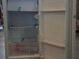 an open refrigerator sitting on the floor in a room