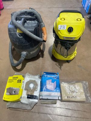 two vacuums that are sitting on the floor next to each other