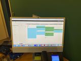 a computer monitor and a cell phone on a desk