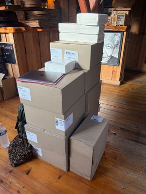 several boxes stacked on top of each other on a wooden floor