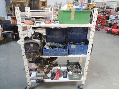 a cart with many tools on it in a warehouse