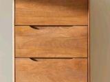 a wooden chest of drawers with a plant on top of it