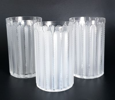 three clear glass vases sitting on top of a black table