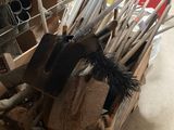 a wooden box filled with tools and a basket full of brooms