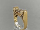 a close up of a gold ring with a diamond on it