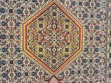 an antique persian rug with a medallion design on a blue ground