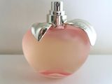 a pink apple shaped perfume bottle with a silver top