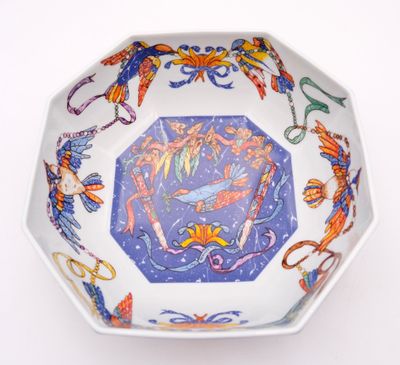 a bowl with a design on it on a white surface