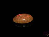 une image représentant un objet noir sur lequel brille une lumière rouge