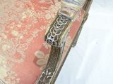 a close up of a chair that has a bird on it