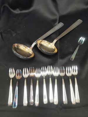 a lot of silver spoons and forks on a table