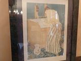 a framed picture of a woman washing her hands in a sink